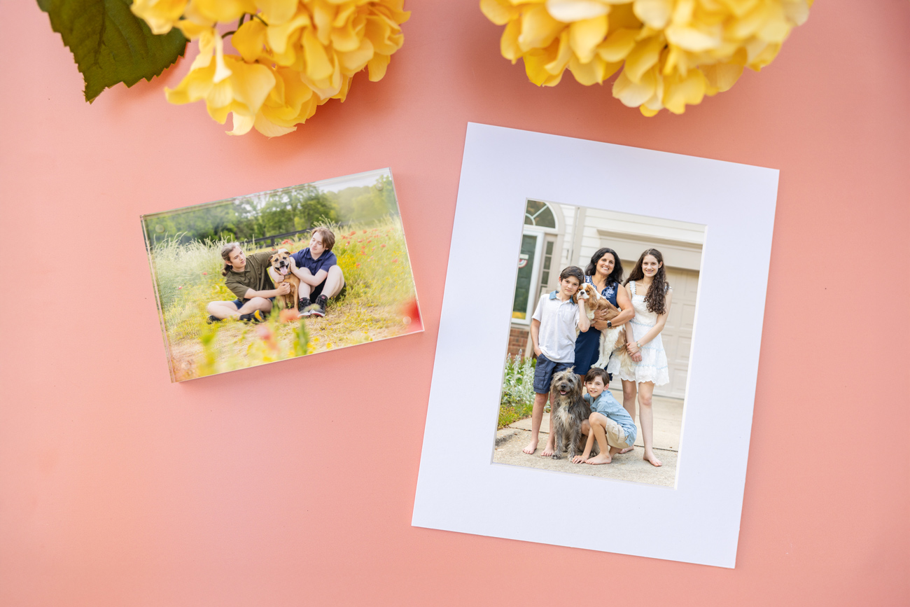 overhead image of photography products (matted print and acrylic block) on a peach colored background